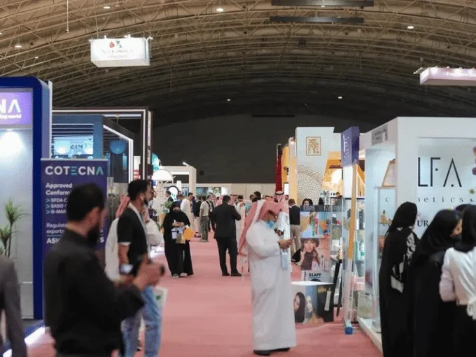 Visitors exploring exhibition booths at a trade show in Saudi Arabia with reliable convention and trade show transportation services